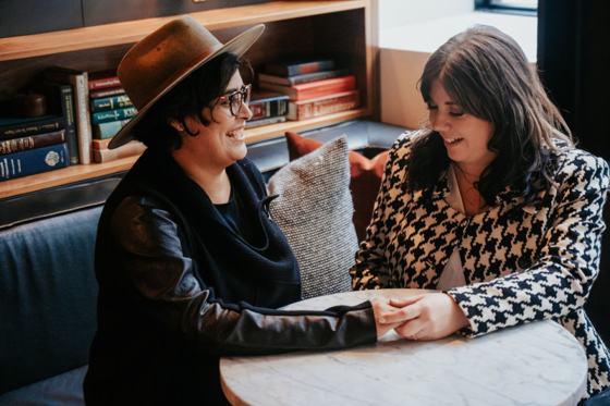 Couple reading together among bookshelves