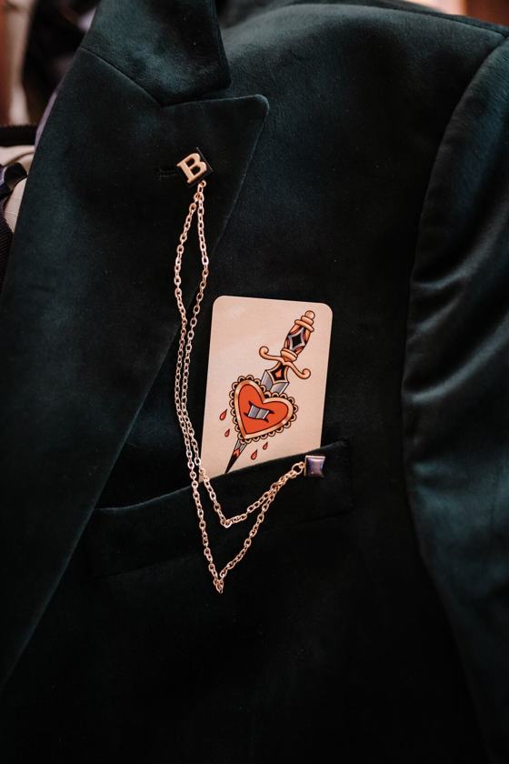 Playing card tucked behind a suit lapel