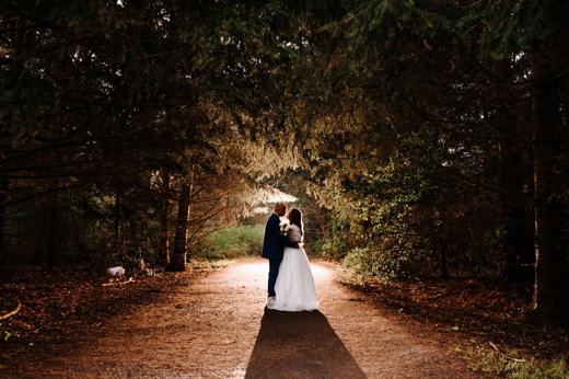 Ceremony aisle set between tall trees
