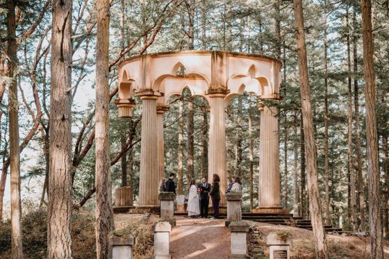 Ceremony beneath an arbor built of forest branches