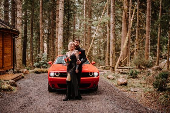 Vintage red car parked on an empty forest road