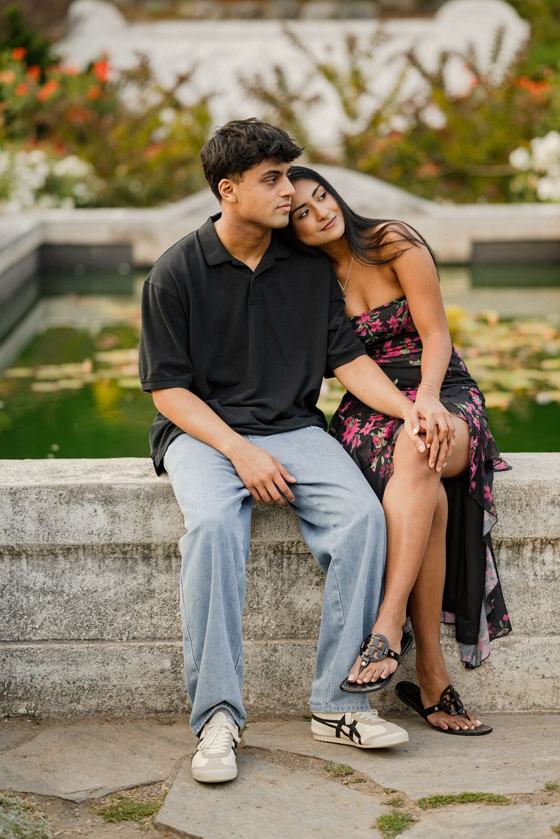 Couple sitting on a bench beside a fountain