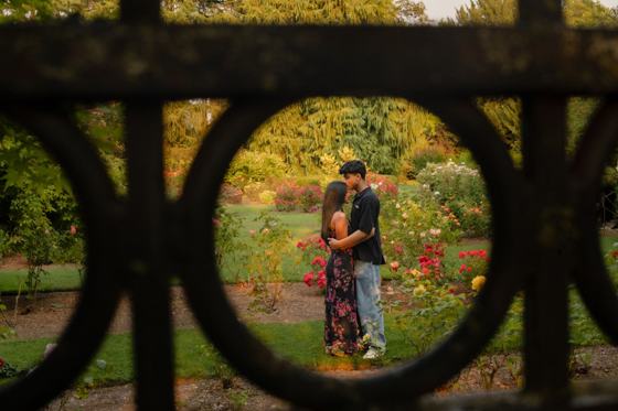 Couple framed by an arched garden gate