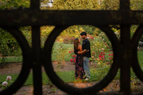 Couple standing inside a circular garden gate