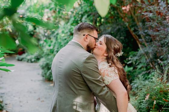 Kiss surrounded by dense garden greenery
