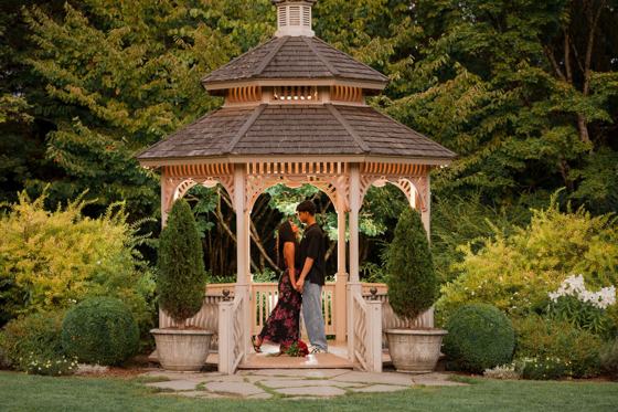Couple standing inside a garden gazebo