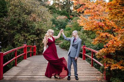 Couple dancing on the red bridge at Kubota Garden