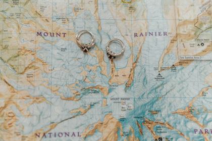 Wedding rings resting on a Mount Rainier trail map
