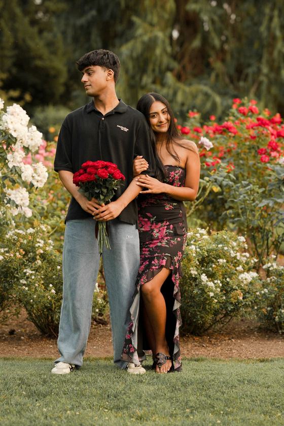 Couple embracing among climbing roses