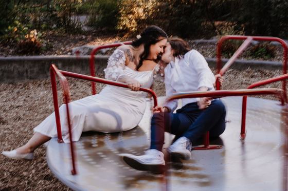 Couple beside a lit park carousel