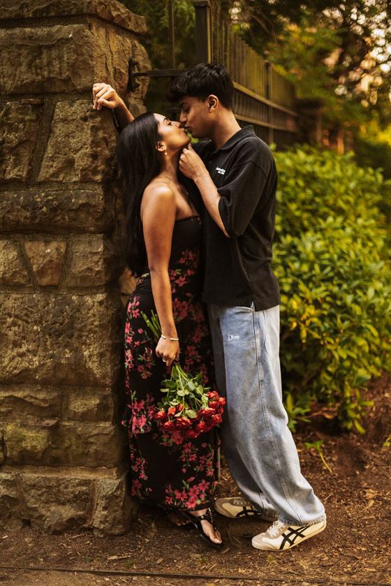 Kiss against an old stone wall