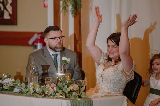 Toast being raised at a wedding reception table